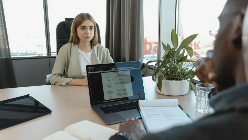 Entrevista de selección de personal con documentación de candidatura, en un contexto de uso de inteligencia artificial para analizar currículums